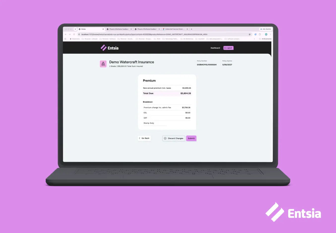 Laptop showing grey, black and pink login screen on a pink background